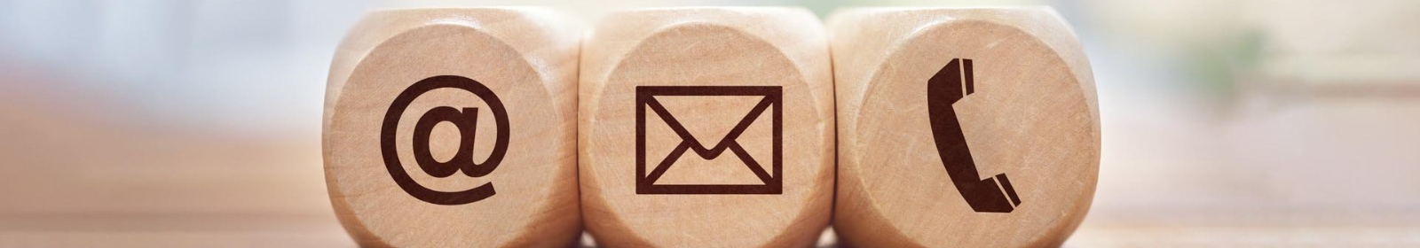 three wooden block with an @, envelope and phone symbol